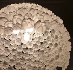 the light fixture is made out of paper flowers