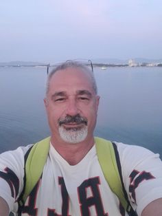 a man taking a selfie while on a boat