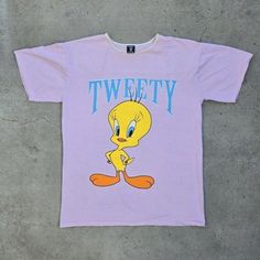 1996 Tweety Bird Shirt Perfect Condition Measurements: Pit To Pit: 24" Length: 34" Size: One Size Fits All #Disney #Cartoon #Cartoontees #Tweetybird #90s 90s Style Yellow Cotton T-shirt, Yellow Crew Neck T-shirt In Y2k Style, Yellow Retro Shirt With Letter Print, Retro Streetwear Tops With Cartoon Print, Retro Yellow Tops With Logo Print, Retro Tops With Cartoon Print For Streetwear, Retro Cartoon Print Tops For Streetwear, Retro Yellow Shirt With Screen Print, Retro Yellow Crew Neck Shirt