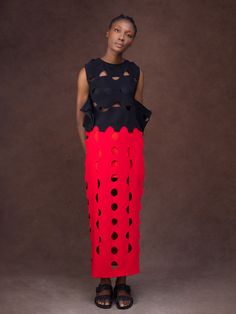 At once glamorous, playful, and empowering, this two-piece set captures the unique design aesthetic of Nigerian label Gozel Green. Comprising a sleeveless peplum top and a midi skirt, it’s been handcrafted in Lagos, Nigeria, from lightweight crepe infused with a touch of stretch to ensure comfort. Finished with skin-baring cutouts and scalloped edges for a touch of ladylike finesse, style yours with metallic heels and a swipe of red lipstick. - Two-piece set - Sleeveless top with a round neck, c Chic Midi Dress With Ruffles, Two-piece Dress With Long Skirt For Party, Chic Midi Skirt Dress With Ruffles, Avant-garde Sleeveless Party Dress, Modern Skirt For Summer Parties, Red Midi Party Dress, Modern Summer Skirt For Party, Red Two-piece Party Dress, Red Two-piece Dress For Party