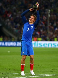 the soccer player is holding his hands up in celebration on the field at an event