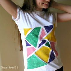 a girl wearing a t - shirt with an abstract design on it