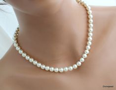 This timeless necklace has lustrous Austrian pearls in cream.  It's finished off with lobster claw closure and 2" extender chain at the back for extra length.  Please choose desired pearl and finish color at checkout.  This beauty can be made with either 8 or 6 mm pearls.  Please choose yours at checkout! Perfect for a classy bride or any special occasion!  Necklace is available from bold to dainty pearls, choose your at checkout! Pearls measure 8 mm in diameter.   Standard length is 17" long. Available in three finishes, silver, gold and rose gold. Pearls are available in different shades, please see color charts in last two pictures.  If you don't see the color you need, contact me happy to help! Please take a look at the rest of the MAKAYLA Collection! http://www.etsy.com/shop/DivineJew Elegant Single Strand Cream Pearl Necklace, Elegant Cream Single Strand Pearl Necklace, Cream Pearl Necklace For Formal Occasions, Formal Cream Pearl Necklace, Formal Cream Necklace With Pearl Charm, Cream Pearl Drop Necklace For Wedding, Elegant Cream Pearl Necklace For Wedding, Cream Pearl Necklace With Pendant For Wedding, Cream Pearl Pendant Necklace For Wedding