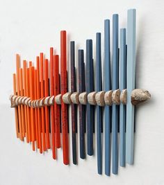 an assortment of colored sticks are arranged on a wall