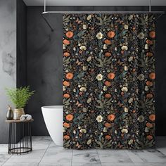 a black shower curtain with oranges and leaves on it next to a bathtub