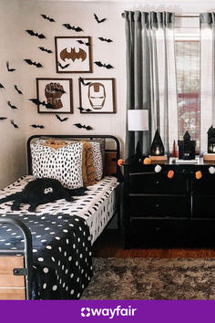 a bedroom decorated for halloween with black and white decor