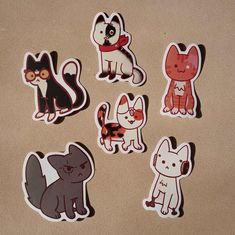 six stickers with different types of cats and dogs on them sitting on a table