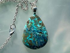 A beautiful and rare Shattuckite necklace on a 18 inch  steel necklace.  I sliced the stone and hand shaped and polished it using lapidary equipment. My wife, who has smaller hands then me, then strung it on the chain. Each pendent is a unique, one of a kind creation and you will not find another one just like it. Metaphysically, Shattuckite is believed to promote clarity of mind, heart, and throat. It helps in communicating truths, helping you to speak clearly and honestly from the heart. Blue Chrysocolla Necklace With Large Stone, Oval Chrysocolla Necklaces As Gifts, Healing Chrysocolla Pendant Turquoise Necklace, Oval Chrysocolla Necklace As A Gift, Oval Chrysocolla Necklace Gift, Teardrop Necklace With Large Stone For Jewelry Making, Chrysocolla Necklace With Large Pendant As Gift, Unique Teardrop Large Stone Necklace, Untreated Teardrop Pendant Necklace As A Gift