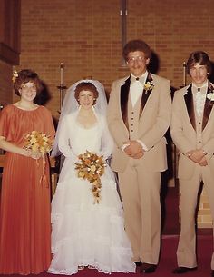 a group of people standing next to each other in front of a church alter wearing suits and ties