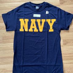 Us Navy Core Physical Training Military Pt T-Shirt Navy/Gold Size Medium Gildan 100% Cotton Chest Measures ~19" Armpit To Armpit Length 28.5" Comes From Smoke-Free/Pet-Free Home Navy Pre-shrunk Cotton T-shirt, Navy Graphic Tee With Letter Print, Navy Cotton Fan Apparel Tops, Navy Short Sleeve Top With Letter Print, Navy T-shirt With Letter Print For Streetwear, Navy Letter Print T-shirt For Streetwear, Navy Graphic Tee With Crew Neck, Navy Graphic Tee Shirt With Crew Neck, Navy Crew Neck Tops With Text Print