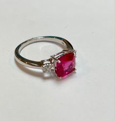 Celebrate her July birthday with this timeless fashion ring. This minimalist-chic ring for her features a cushion lab-created ruby and shimmering round two(.01ctw) Diamonds. Center Stone: 8mm Cushion Lab Created Ruby Side Stones: .01ctw Round Diamond Please visit our store for more jewelry https://www.etsy.com/shop/ritapierredesigns SHIP TIME: Orders Ship Free via USPS First Class All orders can be upgraded to priority for an additional fee. RETURNS: We want you to be completely happy with your Anniversary Lab-created Ruby Cushion Cut Jewelry, Luxury Sterling Silver Ruby Ring With Brilliant Cut, Luxury Diamond-cut Ruby Ring Gift, Silver Diamond-cut Ruby Ring For A Gift, Exquisite Brilliant-cut Ruby And Diamond Ring, Ruby Diamond Ring, Chic Rings, Ruby Birthstone, Ring Ruby