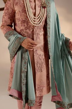 Orchid Pink Sherwani | Jatin Malik Introducing our stunning orchid pink sherwani, a true masterpiece of elegance and sophistication. This sherwani is adorned with intricate hand embroidery details, featuring shades of pink and zari that create a mesmerizing visual impact. Each stitch is meticulously crafted to enhance the richness of the design, making this ensemble a work of art. Perfect for those who appreciate refined craftsmanship and timeless style, this orchid pink sherwani is sure to make a statement at any special occasion or event. Included in purchase: Sherwani, Kurta, Churidar, Safa Product Specification Color: Dark pink Fabric: Linen silk Occasion: Engagement, Wedding, Bridal, Reception Style: Sherwani, Kurta, Churidar, Safa Care: Dry Clean Work: Hand Embroidery Customization o Pink Kurta With Chikankari Embroidery For Reception, Pink Chikankari Embroidery Kurta For Reception, Pink Traditional Churidar For Transitional Season, Transitional Pink Churidar With Traditional Drape, Formal Pink Kurta With Naqshi Detailing, Pink Kurta For Reception And Transitional Season, Pink Traditional Naqshi Sherwani, Pink Churidar For Reception, Elegant Pink Churidar For Reception