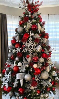 a decorated christmas tree with red and silver ornaments