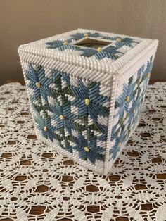 a small blue and white basket sitting on top of a table