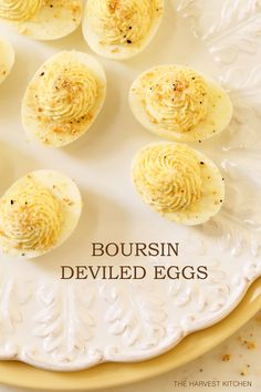 deviled eggs on a white plate with the words bourssin deviled eggs