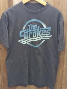 The Strokes Vin Shirt Shipping from the US. Easy 30 day return policy, 100% cotton, Double-needle neck, sleeves and hem; Roomy Unisex Fit. The Strokes Shirt, Types Of Cotton Fabric, Vintage Band Shirts, Vintage Band T Shirts, Pit Stains, Outfit Inso, Shirt Wrinkles, The Strokes, Rock'n Roll