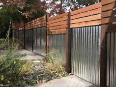 a wooden fence with metal slats on it