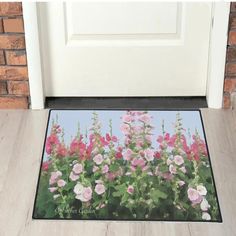 a door mat with pink and white flowers on it