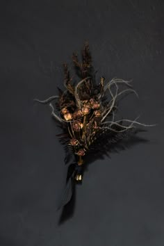 an arrangement of dried flowers on a black background