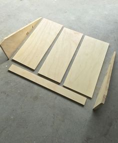 three pieces of plywood sit on the ground