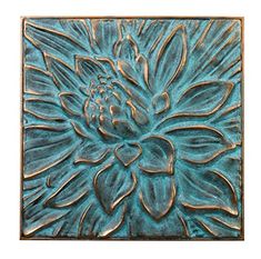 a blue flower is shown in the center of a square metal plaque on a white background