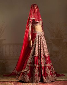 Step into a world where the whispers of persian culture meet the vibrant hues of love with our red geometric jewelled lehenga set. This enchanting ensemble, adorned with intricate tree motifs symbolizing a bride's transformative journey, features a stunning red lehenga, a matching blouse, and a luxurious dupatta with scalloped edges. The timeless red hue, embodying tradition and prosperity, takes center stage, radiating passion and fortune. Elegant Red Palazzo Set With Intricate Embroidery, Red Designer Wear Sets With Traditional Drape, Red Traditional Drape Sets For Designer Wear, Red Palazzo Set With Intricate Embroidery And Traditional Drape, Red Palazzo Set With Intricate Embroidery, Red Embroidered Palazzo Set For Festivals, Red Festive Sets For Reception, Festive Red Sets For Reception, Designer Red Palazzo Set With Intricate Embroidery