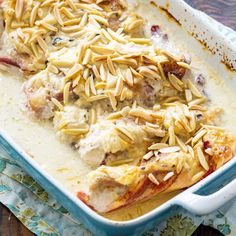 a casserole dish with chicken, cheese and almonds