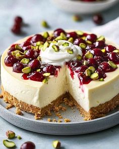 a cheesecake topped with cherries and pistachios