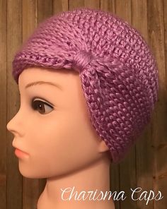 a close up of a mannequin head wearing a purple knitted beanie