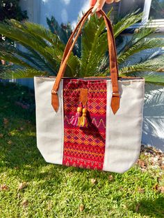 This stunning embroidered tribal tote bag is an absolute must-have. Incredible detailing with breathtaking colors that will have everyone complimenting. Beautifully made by Artisans in Mexico.  Large enough to use for shopping, use as a diaper bag, school, beach, and everyday use.  Please advise that each bag is handmade and each design will vary. Colors may slightly be different due to photo editing and natural light placement. If you want a specific one please message me.  Measurements: 12 inc Woven Travel Tote Bag, Bohemian Natural Canvas Bag For Everyday Use, Bohemian Large Capacity Tote Canvas Bag, Bohemian Large Capacity Canvas Tote Bag, Travel Tote Bag With Weaving Work, Travel Tote Shoulder Bag With Weaving Work, Embroidered Natural Tote Shoulder Bag, Embroidered Natural Shoulder Bag For Travel, Bohemian Natural Canvas Bag For Travel