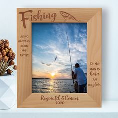 a man is fishing on the water at sunset with his name and date printed on it