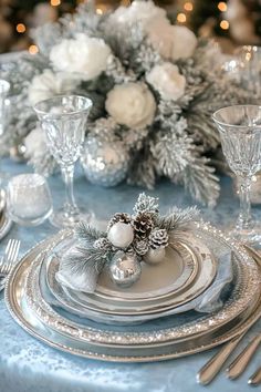 the table is set with silver and white decorations