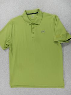 a green polo shirt laying on the floor