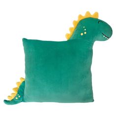 a green dinosaur pillow with yellow spikes on it's head and eyes, sitting against a white background