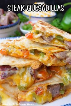 a stack of quesadillas sitting on top of a white and blue plate