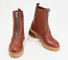 a pair of brown boots with zippers on the side and white outstep