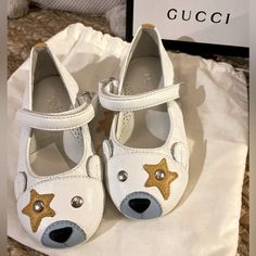 New Never Worn! Authentic Gucci Baby Toddler Girls Leather Bear Toe Ballet Shoes With Silver Accent Buttons On Bearface And Star Leather Custom Design. Size Euro 21-22 Fits U.S. 5 Or 6. Show Is Made From Flexible Soft But Sturdy White Cream Colored Leather. Has Velcro Strap Silver Gucci Clasp Closures. This Legendary Italian Fashion House Founded By Guccio Gucci In Florence In 1921. One Of The Top Luxury Brands In The World, The Label Produces Designer Clothing, Shoes, Jewelry, Handbags, And Acc Gucci Baby, Guccio Gucci, Colored Leather, Toe Shoes, Fashion House, Gucci Shoes, Luxury Brands, Velcro Straps, Italian Fashion