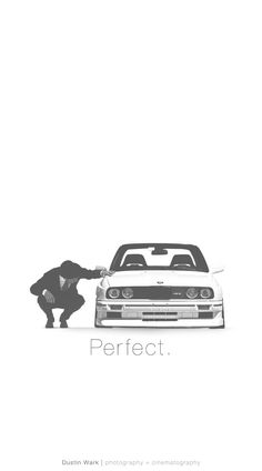 a man kneeling down next to a car with the word perfect on it's side