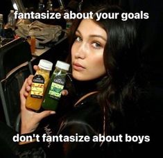 a woman holding two bottles of hair care products in front of her face and the caption says, fantasize about your goals don't fantastic about boys