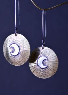 "Long dangle moon earrings. The \"Eclipse Rising\" earrings feature sterling silver crescent moons on hand stamped and carved brass OR sterling silver, choose option at checkout. Attached to long sterling silver earwires. The moon earrings have been given a patina to darken certain areas for character. Sanded and polished for a refined rustic appearance. These statement earrings are perfect for any moon jewelry collection and gift. These are available in all sterling silver or brass with sterlin Crescent Moon Jewelry, Earrings Moon, Crescent Earrings, Bolo Ties, The Eclipse, Handmade Gifts For Her, Celestial Jewelry, Moon Jewelry, Silver Moon