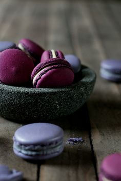 purple macaroons in a bowl on a wooden table