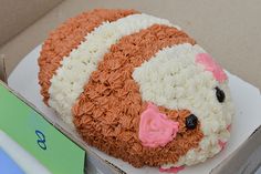 a cake in the shape of a sheep is sitting on top of a cardboard box