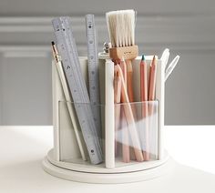 there are many pencils and rulers in the holder