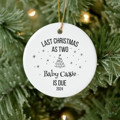 a christmas ornament hanging on a tree with the words last christmas as two baby casie is duee