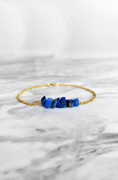 Maat. Inspired by the ancient egyptian goddess Maat. This bracelet is composed of 14K gold vermeil delicate chain and raw lapis lazuli gemstones in royal blue shades. So delicately pretty for everyday! It also makes a very cute gift! Available in: ❉ 14K Yellow Gold vermeil ❉ 14K Rose Gold vermeil ❉ 925 Sterling Silver You can choose between 6 chain lengths: 5.5 / 6 / 6.5 / 7 / 7.5 / 8 inches Not sure which length to buy? We can add a 1 inch extender chain. Just write a note at checkout! ❈ We sen Lapis Lazuli Bracelet With Natural Stones As Gift, Lapis Lazuli Bracelets With Natural Stones As Gift, Gift Bracelet With Lapis Lazuli Natural Stones, Lapis Lazuli Natural Stone Bracelet As A Gift, Lapis Lazuli Gemstone Beads Bracelets As Gift, Lapis Lazuli Bracelet With Natural Stones, Sapphire Lapis Lazuli Bracelets As Gift, Blue Spiritual Bracelets With Birthstone, Spiritual Blue Birthstone Bracelets