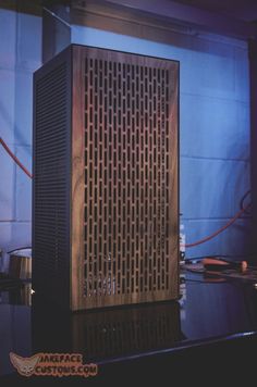 a computer tower sitting on top of a table next to a keyboard and mouse pad