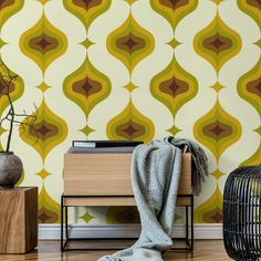 a living room with a wallpaper pattern on the wall and a wooden side table next to it