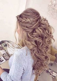 a woman sitting at a table with her hair in a half - updo and braid