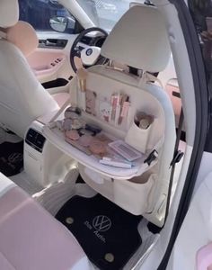 the inside of a car with its door open and various items in it's compartment