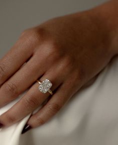 a woman's hand with a diamond ring on it